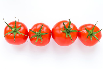 Four delicious ripe red tomatoes on white background lie in a row. Top view. Healthy and organic food concept. Agriculture and harvesting. Vegetable store in supermarket. Illustration for price tag.