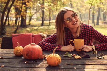 Portrait of beautiful woman enjoying and posing in autumn day.