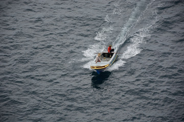 Man driving a boat very fast on the sea