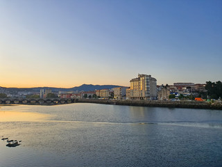 Naklejka premium Sunset and old river bridge