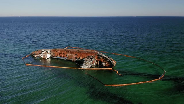 Aerial drone flight over ship Delfi lies aground on its side in Black sea at Odessa, Ukraine, 4K