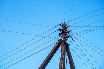 Pole with wires against the sky. Power grid background
