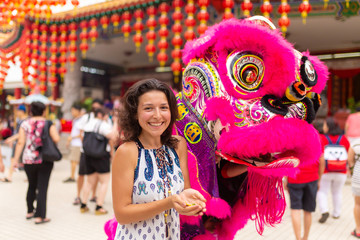 Chinese New Year celebration in a Chinese temple. A Chinese dragon dances and distributes sweets...