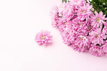 Bouquet of pink flowers on pink background. Romantic background for Valentine Day, Mothers Day or Birthday. Top view.