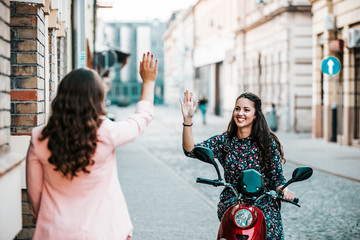 Two happy friends meeting and greeting in the street