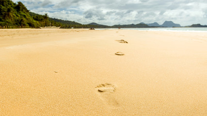 Footsteps on sand on paradise Nacpan beach, El Nido, Palawan, Philippines