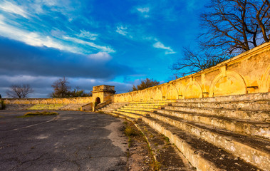 The ruined stands of the old stadium at sunset