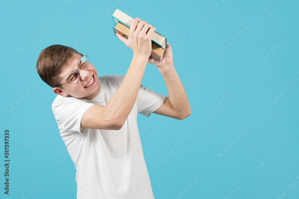 Poster the nerd squints and as if trying to protect himself, keeps books aside