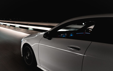 Obraz na płótnie Canvas Sports car on the road at night
