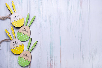 Wooden background for an Easter card with a rabbit and eggs with place for copy space. Happy easter