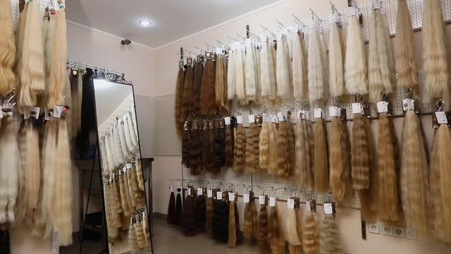 A lot of natural hair for extension on the stand. Fair hair on stand