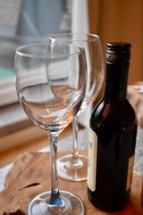 A bottle of wine and glasses on the table for a romantic dinner 