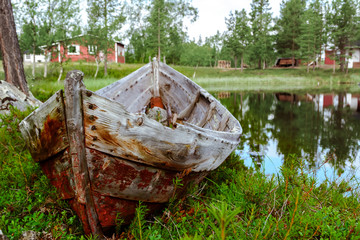 Abandoned wooden boat in the boreal north forest
