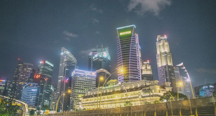 Fototapeta na wymiar SINGAPORE - JANUARY 3, 2020: City skyscrapers at night with beautiful lights