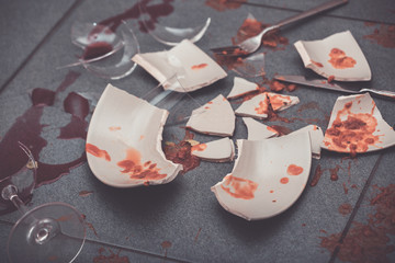 Broken Plate or broken water glass on the on the floor in the kitchen The concept of accidents in...