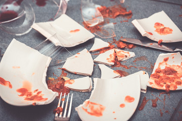 Broken Plate or broken water glass on the on the floor in the kitchen The concept of accidents in...
