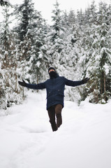 Traveler Man  in winter snowy forest landscape Travel Lifestyle concept adventure active vacations outdoor cold weather into the wild