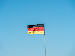 German flag. The German flag blowing in the wind on a clear blue day in spring.