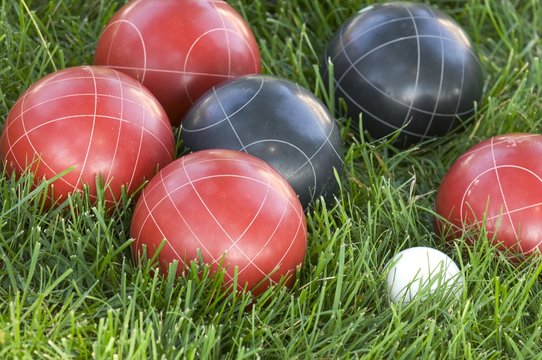 Closeup of colourful bocce balls on the lawn under the sunlight