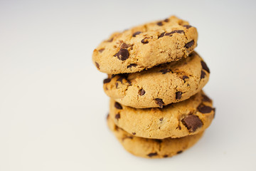 pile of chocolate cookies against white background with copy space