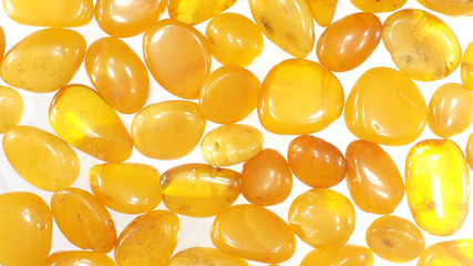 Natural polished amber on a white background