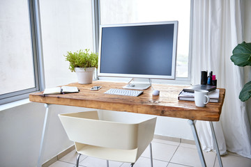Neat desk in a bright corner of a modern work space