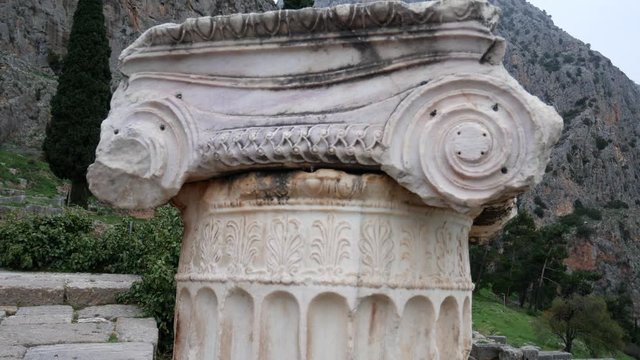 ionic column in the archaeological site of Delphi along the slope of Mount Parnassus, UNESCO World Heritage, Greece.