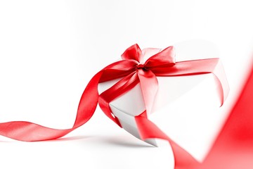 Valentines day gift box with red ribbon isolated on white background. Concept of Valentines, anniversary, mothers day and birthday greeting, copyspace, topview.