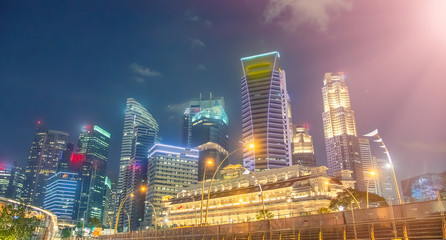 Fototapeta na wymiar Singapore night skyline. Buildings along Marina Bay area