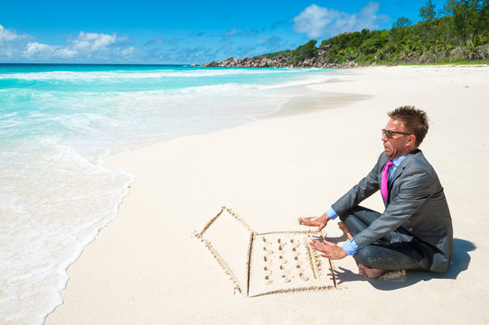 Businessman working on his sand laptop on the beach getting interrupted by an oncoming wave - Powered by Adobe