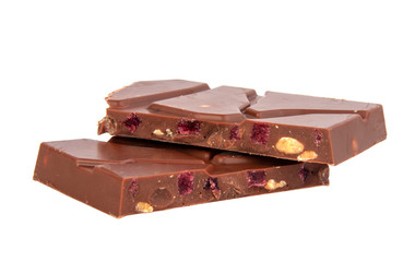 milk chocolate with nuts and berries brocken isolated on the white