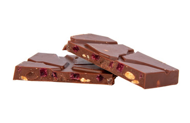 milk chocolate with nuts and berries brocken isolated on the white