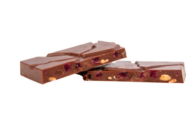 milk chocolate with nuts and berries brocken isolated on the white