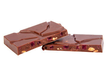 milk chocolate with nuts and berries brocken isolated on the white