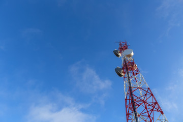 A modern tower antenna for broadcasting telephone, television, and Internet signals. Against the...