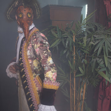 Actors in Steam punk masks and antique costumes indoor.