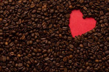 Red heart from coffee beans on coffee background