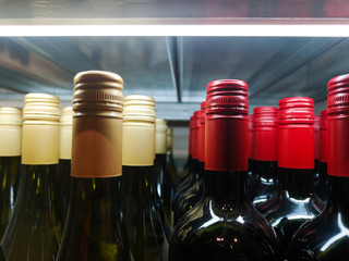 bottles of expensive packaged red wine are on sale at a liquor store