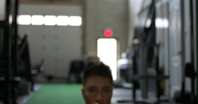 Gay athlete does lunges for crossfire workout. 