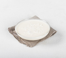 Vanilla Panna cotta, Italian dessert creamy jelly with coconut shavings on a light background