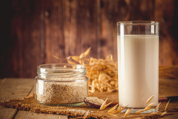 Super Food - A glass of oat milk for a healthy diet. Trending food, vertical photo. Place for your text.
