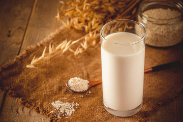 Super Food - A glass of oat milk for a healthy diet. Trending food, vertical photo. Place for your text.