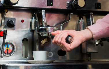 bartender making espresso in coffee mashine 