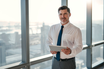 Fototapeta premium My tablet keeps me connected throughout the business day