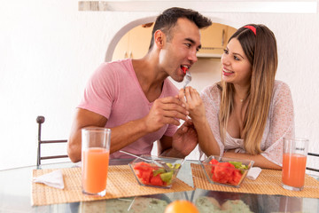 Pregnat couple having a light breakfast.