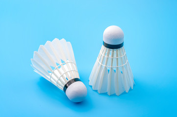 Athletics and team sport concept with badminton shuttlecocks isolated on blue background