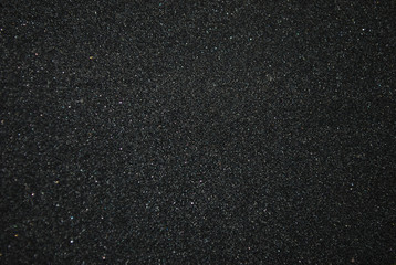 Texture of black sandpaper close-up. Small parts