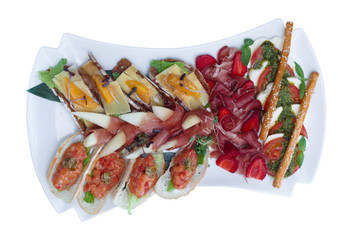 Sliced meat, sandwiches on a white dish. Restaurant serving.