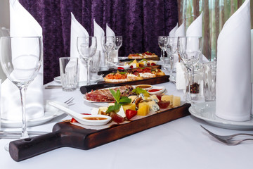 Sandwiches, french fries and sauce on a white dish. Restaurant serving.