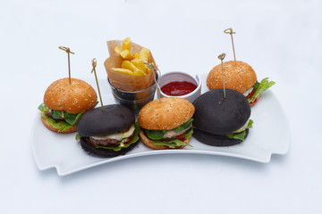 Sandwiches, french fries and sauce on a white dish. Restaurant serving.